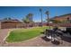 Spacious backyard with manicured lawn, desert landscaping, outdoor grill and cozy seating area at 307 W Piute Ave, Phoenix, AZ 85027
