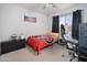 Cozy bedroom with a bed, a modern gaming chair, and a side table next to the window at 307 W Piute Ave, Phoenix, AZ 85027