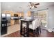 Well-lit kitchen with stainless steel appliances, granite countertops, and a dining table with upholstered chairs at 307 W Piute Ave, Phoenix, AZ 85027