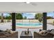 Inviting covered patio with a round pool and stylish wicker furniture for outdoor relaxation at 3707 E Amelia Ave, Phoenix, AZ 85018