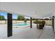 Expansive covered patio with ceiling fans and stylish wicker furniture near a round pool at 3707 E Amelia Ave, Phoenix, AZ 85018