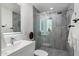 Modern bathroom featuring a sleek glass shower, updated tile, and a stylish vanity with a contemporary faucet at 3707 E Amelia Ave, Phoenix, AZ 85018
