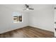 This bedroom offers a calm and inviting space with its wood floors and window overlooking neighborhood at 3707 E Amelia Ave, Phoenix, AZ 85018