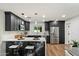 Modern kitchen featuring stainless steel appliances, sleek black cabinetry, and marble countertops at 3707 E Amelia Ave, Phoenix, AZ 85018