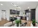 Modern kitchen with stainless steel appliances, black cabinets, and a marble island at 3707 E Amelia Ave, Phoenix, AZ 85018
