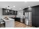 Updated kitchen showcases stainless steel appliances, sleek black cabinetry, and ample counter space at 3707 E Amelia Ave, Phoenix, AZ 85018