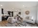Open-concept layout showcasing the stylish living room connected to the modern kitchen and dining area at 3707 E Amelia Ave, Phoenix, AZ 85018