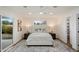 Bright main bedroom with a king bed, stylish rug and a sliding glass door to backyard at 3707 E Amelia Ave, Phoenix, AZ 85018
