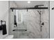 Modern bathroom features a walk-in shower with black hardware and marble tile at 3707 E Amelia Ave, Phoenix, AZ 85018