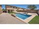 Spacious backyard featuring a sparkling pool, artificial turf, and gravel landscaping, perfect for outdoor living at 3719 E Longhorn St, San Tan Valley, AZ 85140