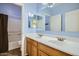Well-lit bathroom featuring a double sink vanity, large mirror, and shower-tub combo with modern finishes at 3719 E Longhorn St, San Tan Valley, AZ 85140