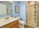 Bright bathroom with a white sink, toilet, walk-in shower, and soft, light-blue painted walls at 3719 E Longhorn St, San Tan Valley, AZ 85140
