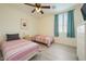 Inviting bedroom featuring two beds, plank floors, a large window, and a ceiling fan at 3719 E Longhorn St, San Tan Valley, AZ 85140