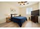 Inviting bedroom with a large window, ceiling fan, blue bedding, and plank-style flooring at 3719 E Longhorn St, San Tan Valley, AZ 85140
