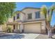 Beautiful two-story home featuring a spacious driveway, attached two-car garage, and covered entryway at 3719 E Longhorn St, San Tan Valley, AZ 85140