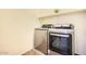 Modern laundry room featuring a stainless steel washer and dryer on a tiled floor at 3719 E Longhorn St, San Tan Valley, AZ 85140