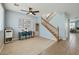 Spacious living area with vinyl floors, a ceiling fan, and a staircase leading to the upper level at 3719 E Longhorn St, San Tan Valley, AZ 85140