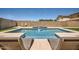 Relaxing pool area featuring lounge chairs and a tranquil waterfall feature for backyard enjoyment at 3719 E Longhorn St, San Tan Valley, AZ 85140
