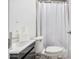 Toilet and sink in a bathroom with a shower curtain at 3913 W Sherman St, Phoenix, AZ 85009