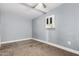 Modest bedroom with carpet, neutral walls, and a ceiling fan at 3913 W Sherman St, Phoenix, AZ 85009