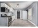 Well-equipped kitchen with stainless steel range, microwave, white cabinets, and sleek gray flooring at 3913 W Sherman St, Phoenix, AZ 85009