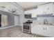 Modern kitchen with white cabinets, stainless steel appliances, and open access to the living area at 3913 W Sherman St, Phoenix, AZ 85009