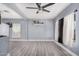 Comfortable living space with stylish gray floors, contemporary ceiling fan, and bright natural light at 3913 W Sherman St, Phoenix, AZ 85009