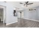 Open living space with modern ceiling fan, sleek gray floors, and convenient access to the kitchen at 3913 W Sherman St, Phoenix, AZ 85009