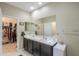 Bathroom with double sinks and plenty of counter space plus entry to the walk-in closet at 41004 W Crane Dr, Maricopa, AZ 85138
