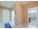 Spacious entryway leading to bathroom and living areas with tile flooring and neutral paint at 41004 W Crane Dr, Maricopa, AZ 85138