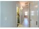 A hallway leading to the laundry room, featuring neutral-colored walls and tiled floors at 41004 W Crane Dr, Maricopa, AZ 85138