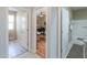Hallway with access to a bathroom, office, and storage, creating a seamless flow between spaces at 41004 W Crane Dr, Maricopa, AZ 85138