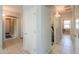 A hallway with doors leading to other rooms, showing neutral colors and tile flooring at 41004 W Crane Dr, Maricopa, AZ 85138