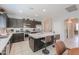 Well-equipped kitchen featuring a central island with seating and stainless steel appliances at 41004 W Crane Dr, Maricopa, AZ 85138