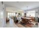 A welcoming living room with a round table, comfortable seating, and natural light from the sliding glass doors at 41004 W Crane Dr, Maricopa, AZ 85138