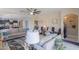 A sunlit living room with comfortable couches, arched doorways, and a partial view of the kitchen at 41004 W Crane Dr, Maricopa, AZ 85138