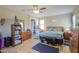 Spacious main bedroom with a wood-look floor, ceiling fan, and plenty of natural light at 41004 W Crane Dr, Maricopa, AZ 85138