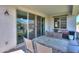 View of a covered patio area with table and chairs, with a sliding door visible on the home's exterior at 41004 W Crane Dr, Maricopa, AZ 85138