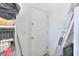 View of indoor storage area with metal rack, ladder, and white door at 41004 W Crane Dr, Maricopa, AZ 85138