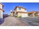 Charming two-story home features a red tile roof, tan stucco, and a two-car garage at 4545 N 67Th Ave # 1101, Phoenix, AZ 85033
