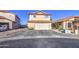 Two-story home featuring a two-car garage, desert landscaping, and a red tile roof at 4545 N 67Th Ave # 1101, Phoenix, AZ 85033