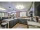Bright kitchen features brick accent wall, island, and stainless steel appliances at 4545 N 67Th Ave # 1101, Phoenix, AZ 85033