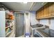 Functional laundry room offers storage shelves, modern appliances, and an exterior access door at 4545 N 67Th Ave # 1101, Phoenix, AZ 85033