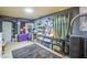 Functional room featuring tile flooring, massage table, storage and plenty of wall decor at 4545 N 67Th Ave # 1101, Phoenix, AZ 85033