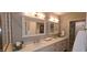 Bright bathroom features a double vanity with quartz countertop, framed mirrors and tile shower at 5640 E Bell Rd # 1047, Scottsdale, AZ 85254