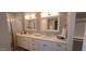 Bright bathroom features a double vanity with quartz countertop and framed mirrors at 5640 E Bell Rd # 1047, Scottsdale, AZ 85254