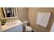A bright bathroom featuring a modern sink, a toilet, a hanging towel, and a mirror at 5640 E Bell Rd # 1047, Scottsdale, AZ 85254