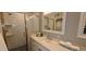 Bathroom features a tile shower with glass door and single vanity with quartz countertop at 5640 E Bell Rd # 1047, Scottsdale, AZ 85254