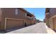 Exterior street view showcasing garages and architectural design elements of modern townhome community at 5640 E Bell Rd # 1047, Scottsdale, AZ 85254