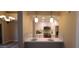 Open-concept kitchen featuring white cabinets, stainless steel appliances, and a breakfast bar at 5640 E Bell Rd # 1047, Scottsdale, AZ 85254
